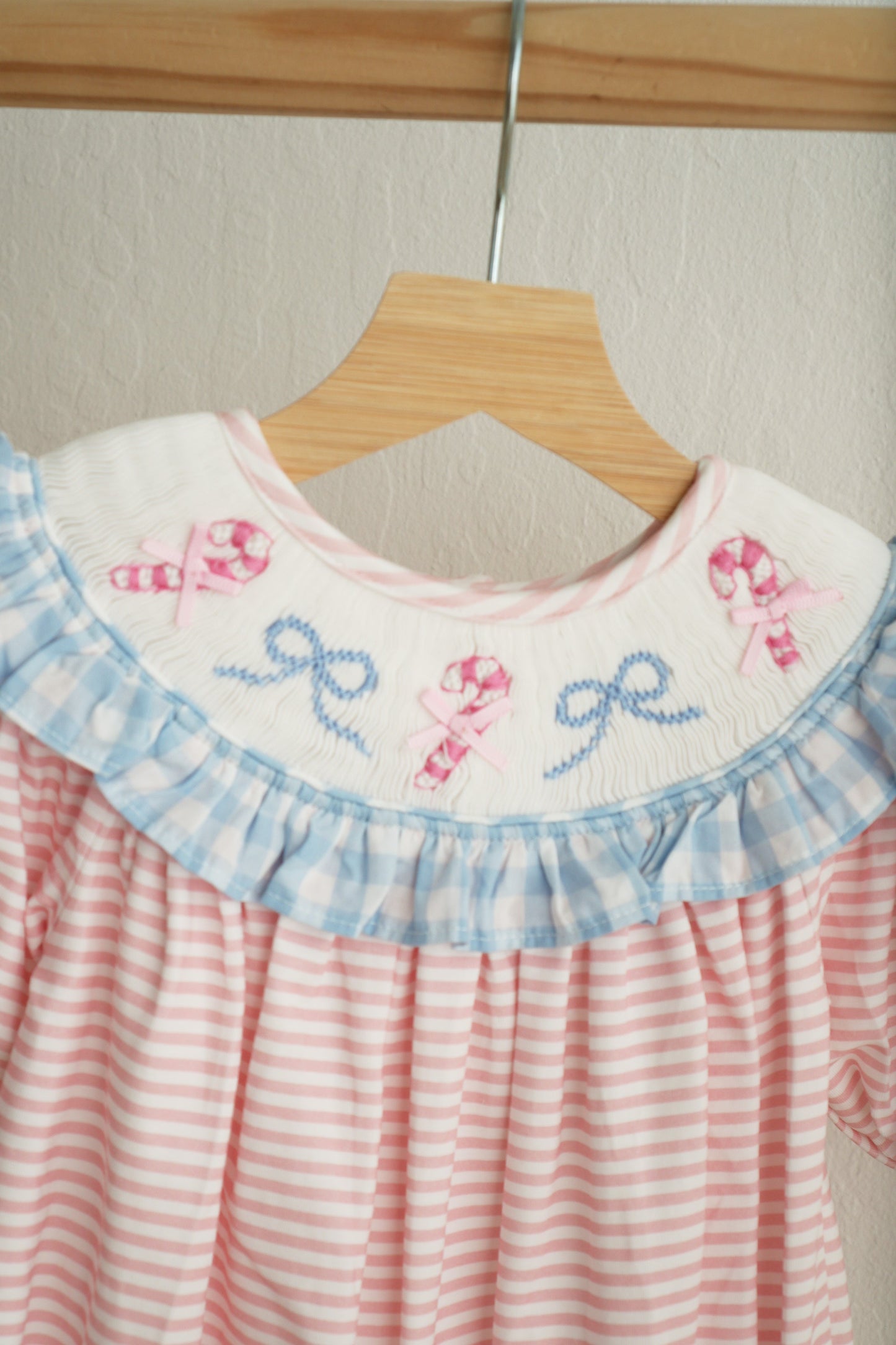Pink candy cane bow hand smocked ruffle romper